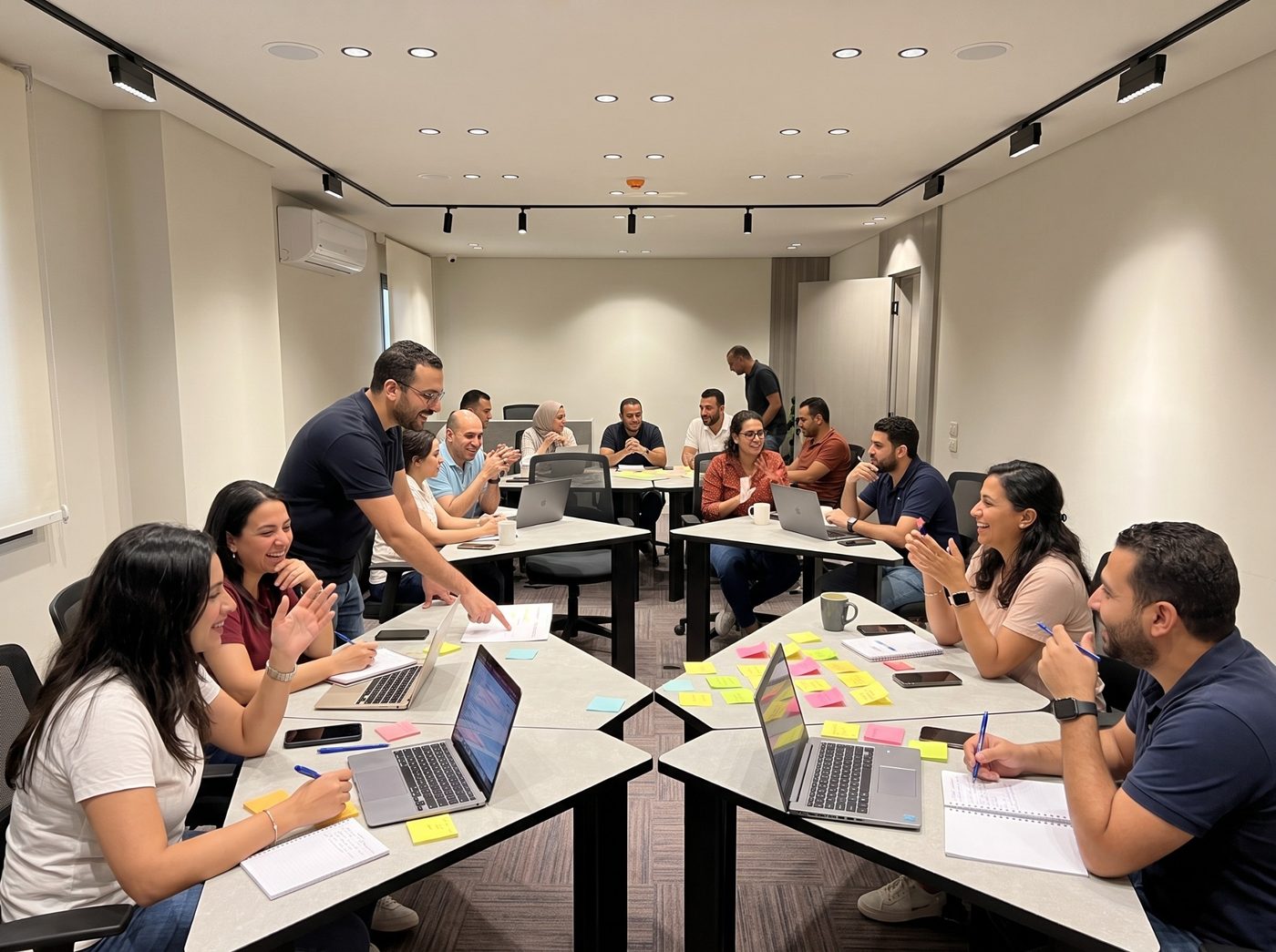 Participants collaborating during a hands-on workshop in a training hall