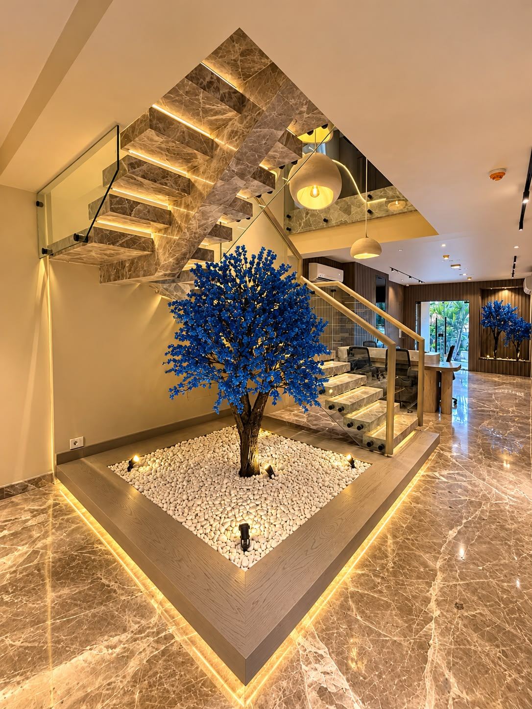 Orillia reception with a floating marble staircase and a blue blossom tree