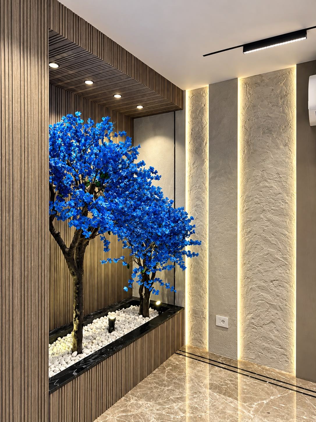 Lobby niche with blue blossom trees and warm wood-slat lighting